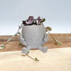 Zabawna doniczka figurka